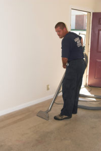 Tech steam cleaning carpet in apartment in charles county